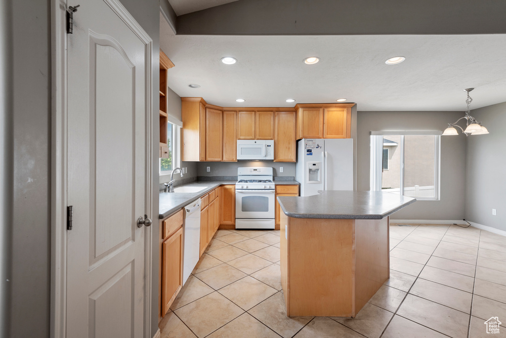 Kitchen with white appliances, a kitchen island, light tile patterned flooring, recessed lighting, and a chandelier