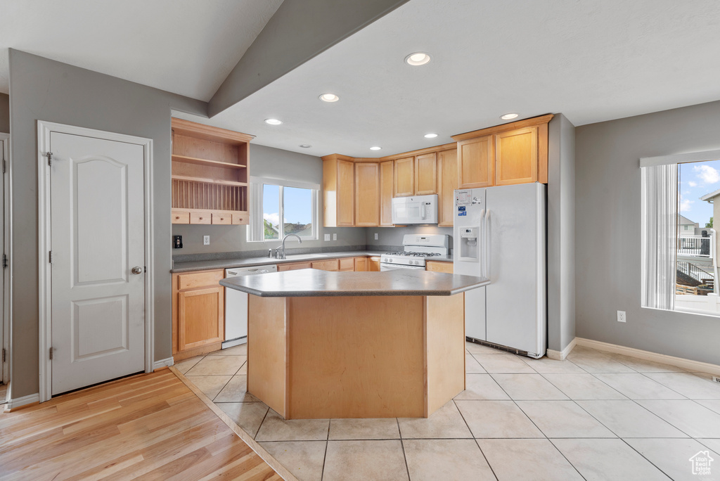 Kitchen featuring white appliances, a center island, open shelves, recessed lighting, and vaulted ceiling