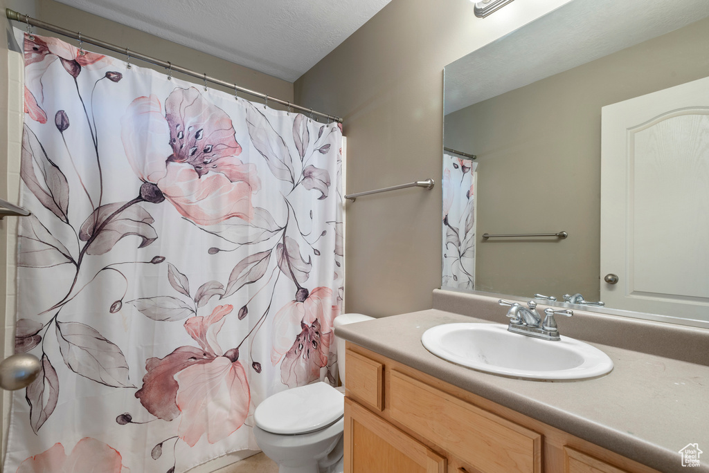 Bathroom featuring vanity and a shower with curtain
