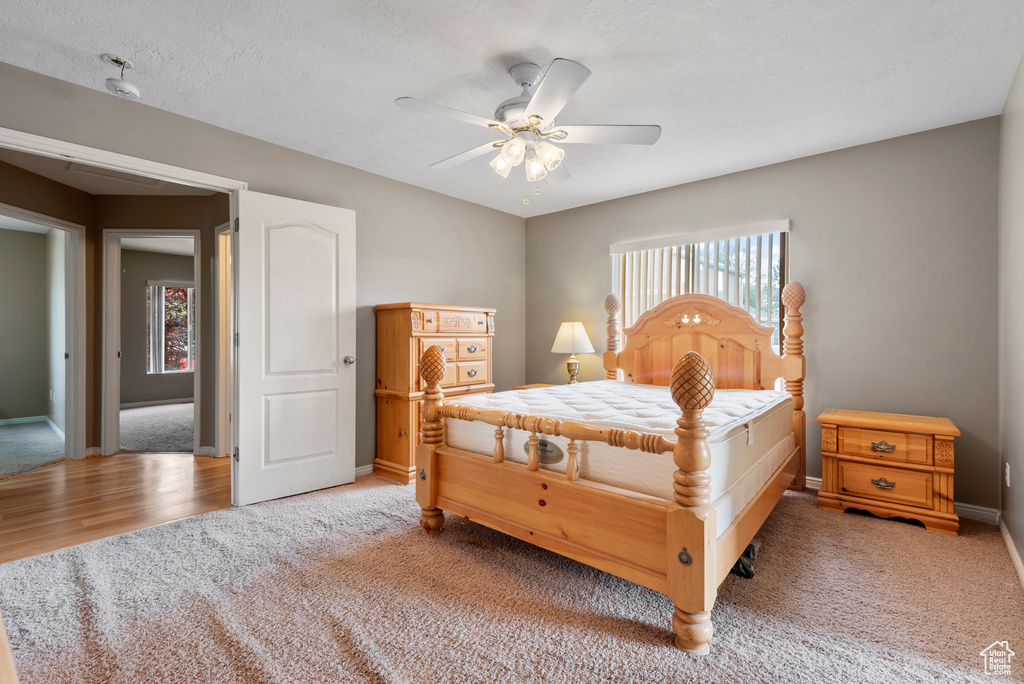 Bedroom featuring light colored carpet and ceiling fan