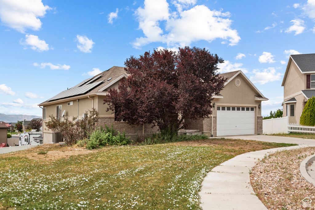 Obstructed view of property with stucco siding and driveway
