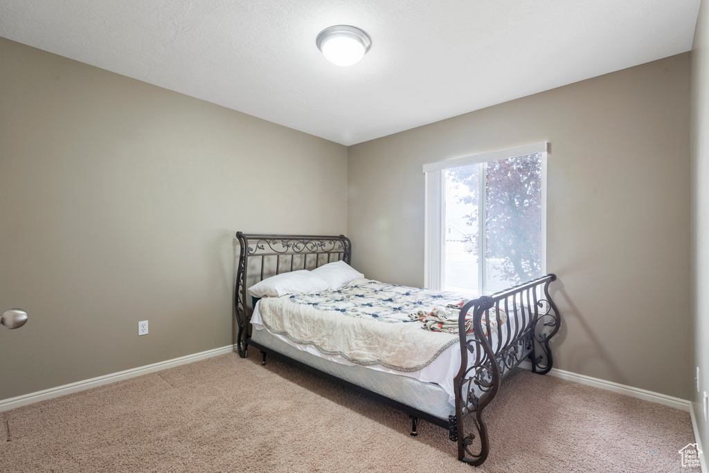 Carpeted bedroom with baseboards