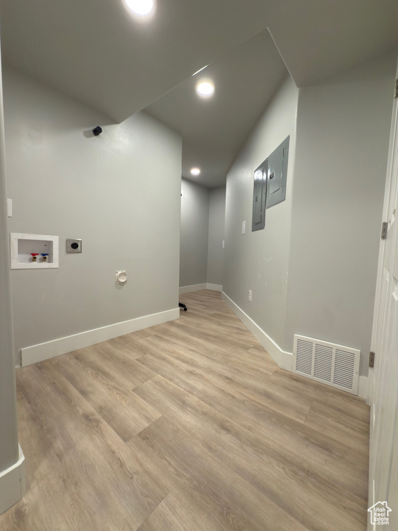 Washroom featuring washer hookup, electric dryer hookup, light wood-style floors, recessed lighting, and electric panel