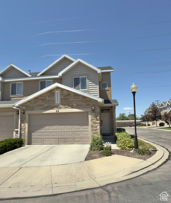 Multi unit property with driveway and stone siding