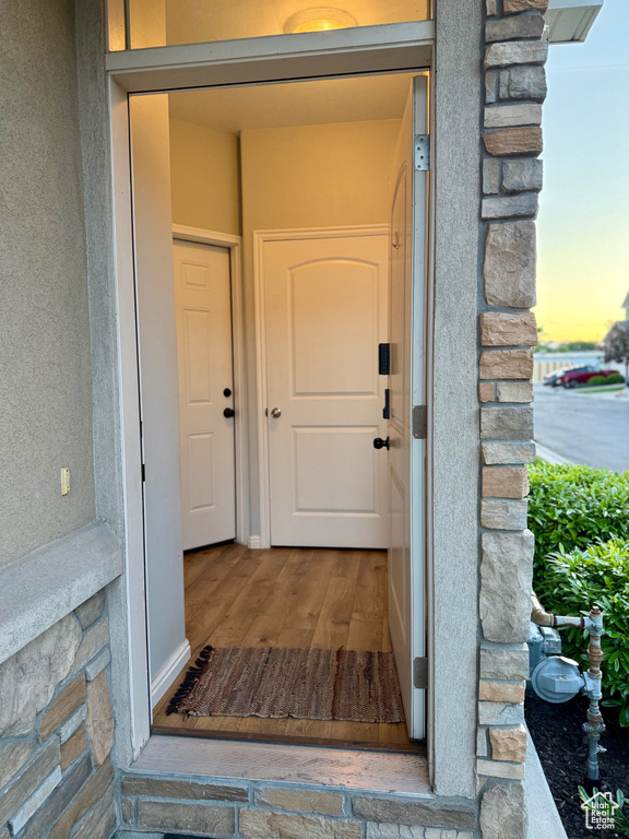 View of exterior entry featuring stone siding and stucco siding