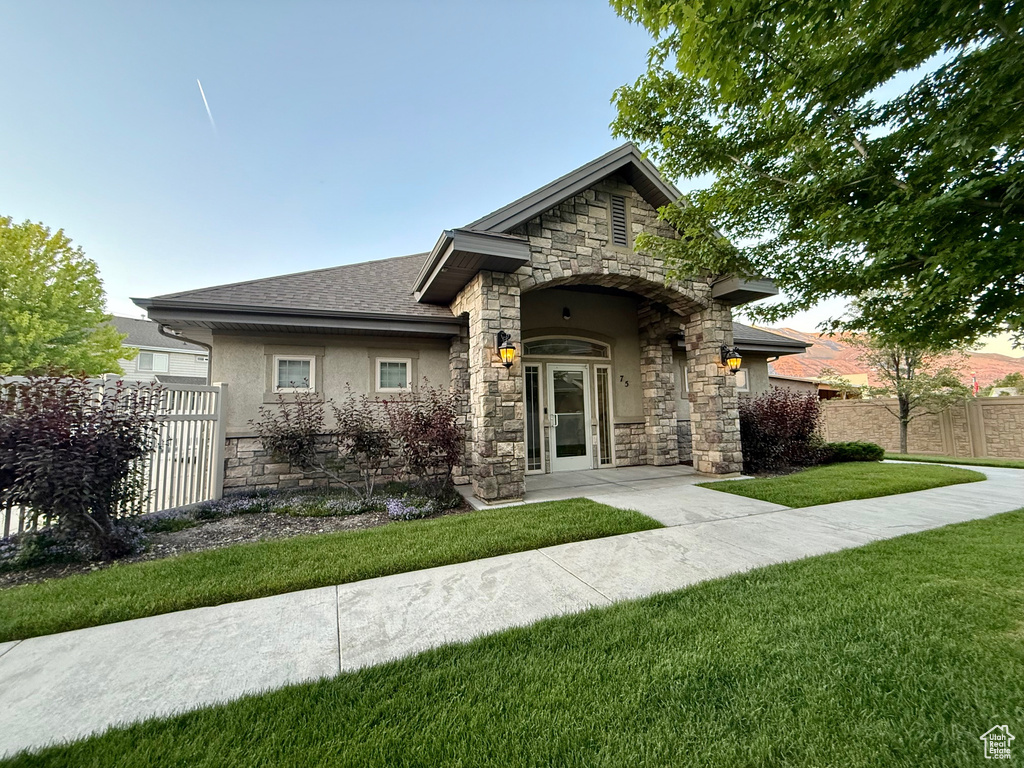 View of front of property with stone siding and stucco siding