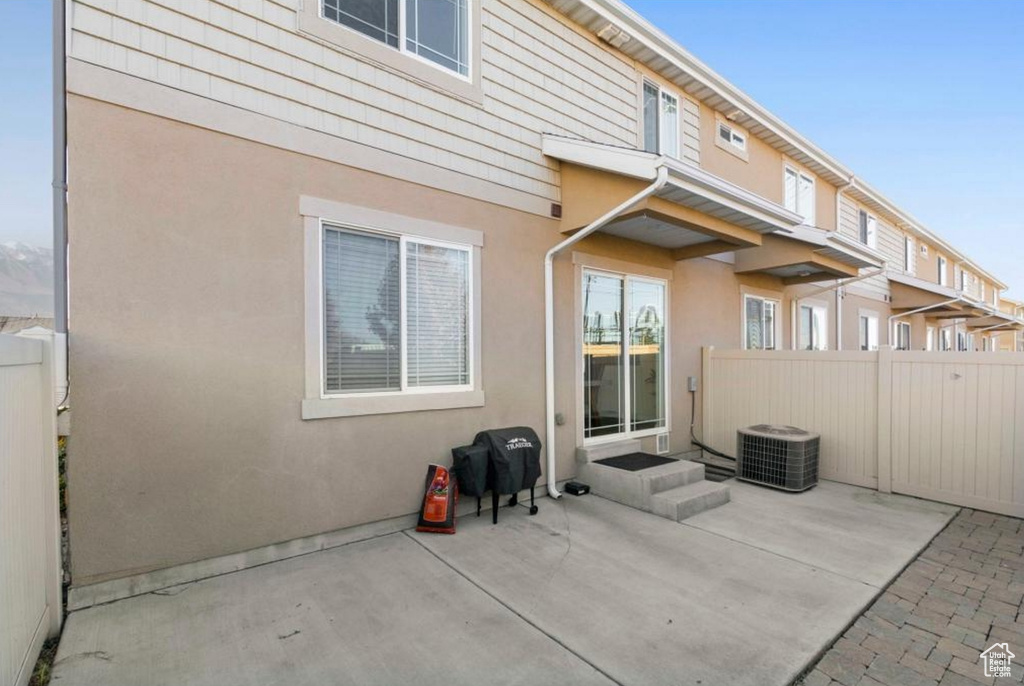 Back of house featuring stucco siding, a patio, and central air condition unit