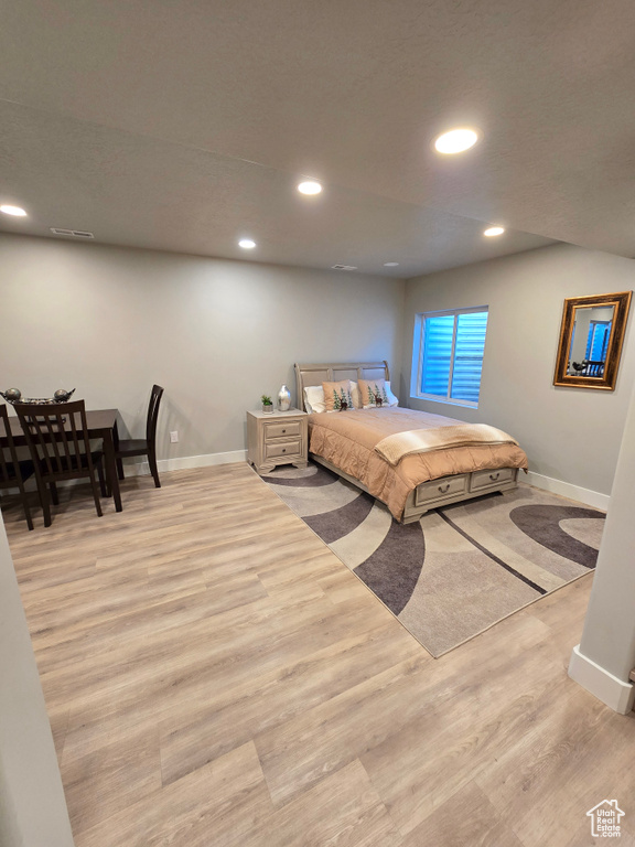 Bedroom featuring baseboards, wood finished floors, and recessed lighting