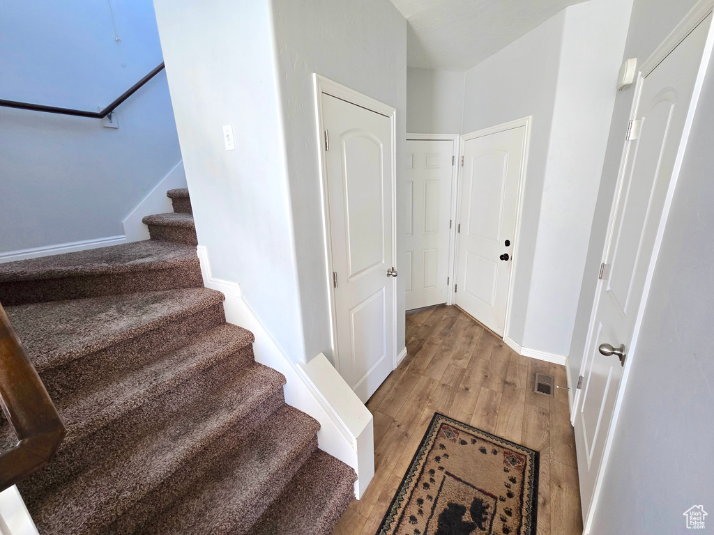 Staircase featuring wood finished floors and baseboards