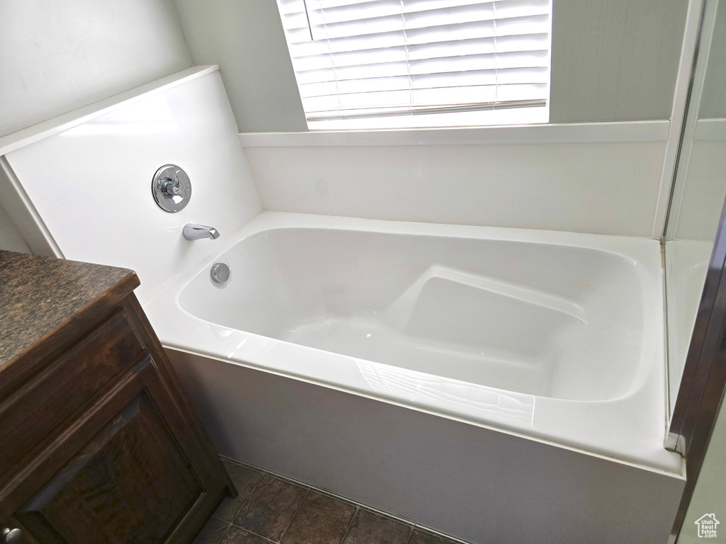 Full bathroom featuring a bath and plenty of natural light