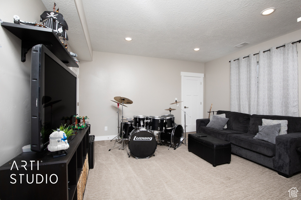 Living room with carpet, recessed lighting, a textured ceiling, and baseboards