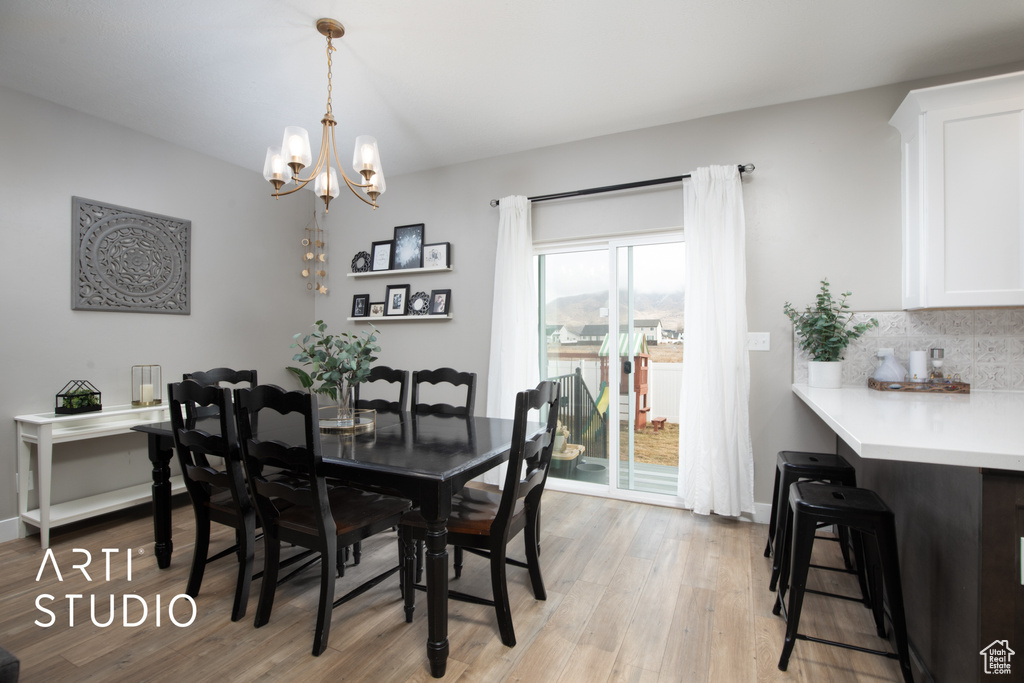 Dining room with a chandelier and light wood-style flooring