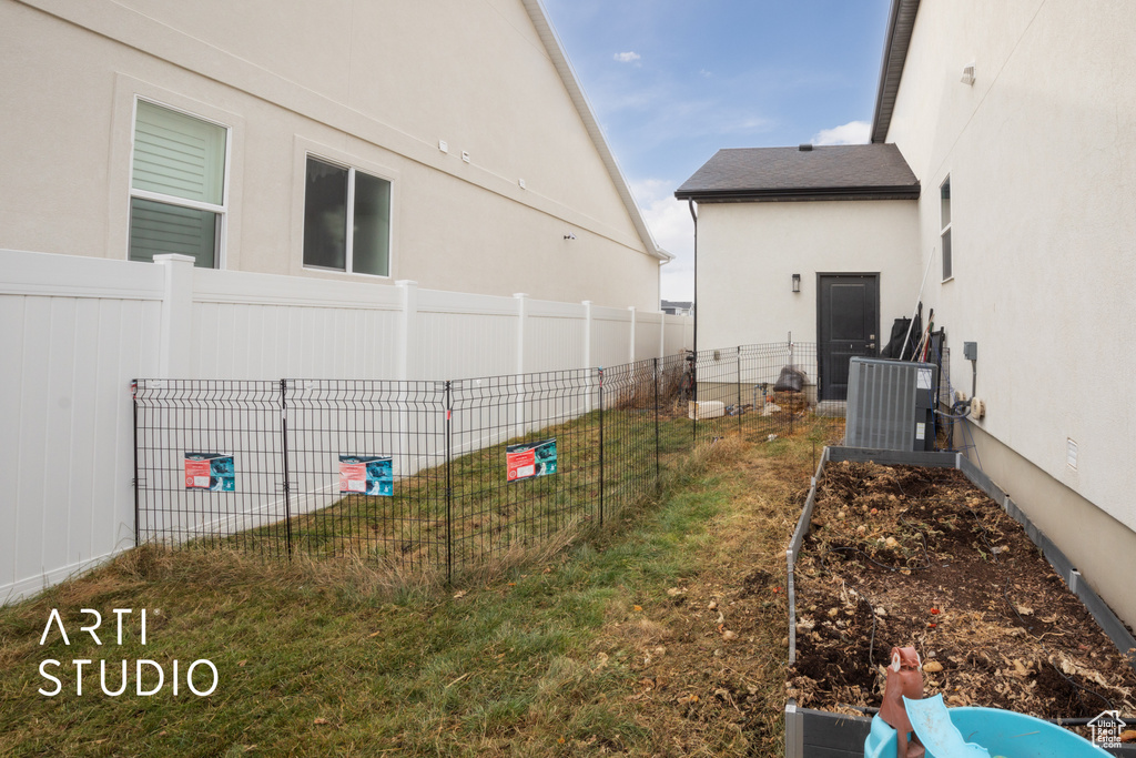 View of yard with central AC unit