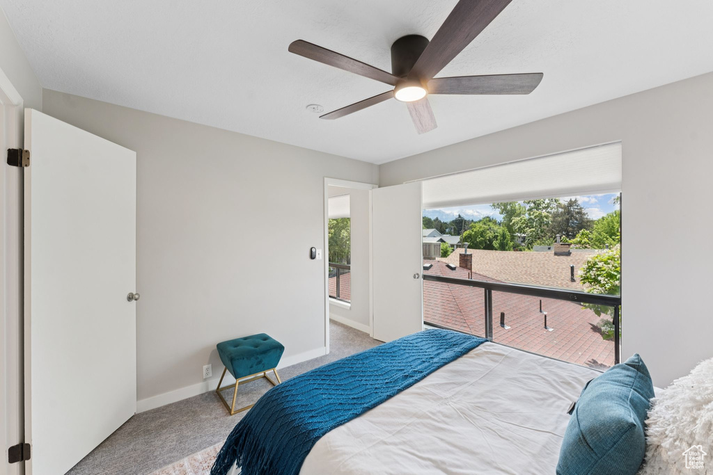 Carpeted bedroom with baseboards, ceiling fan, and access to outside