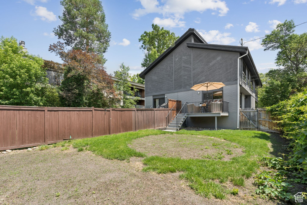 Rear view of house with stairs and a wooden deck