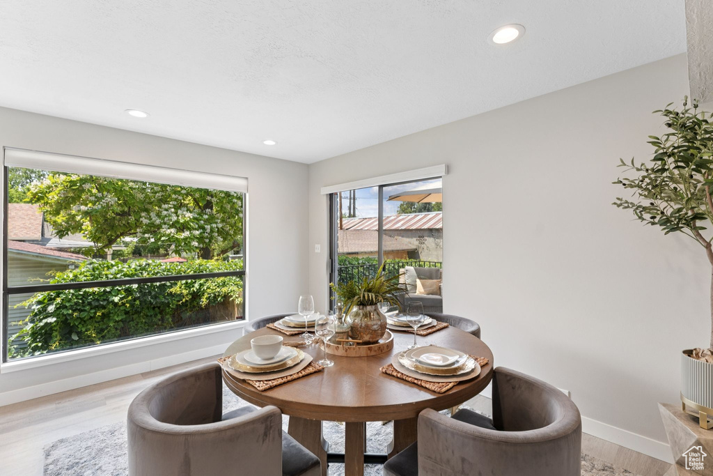 Dining area featuring light wood-style flooring, baseboards, and recessed lighting