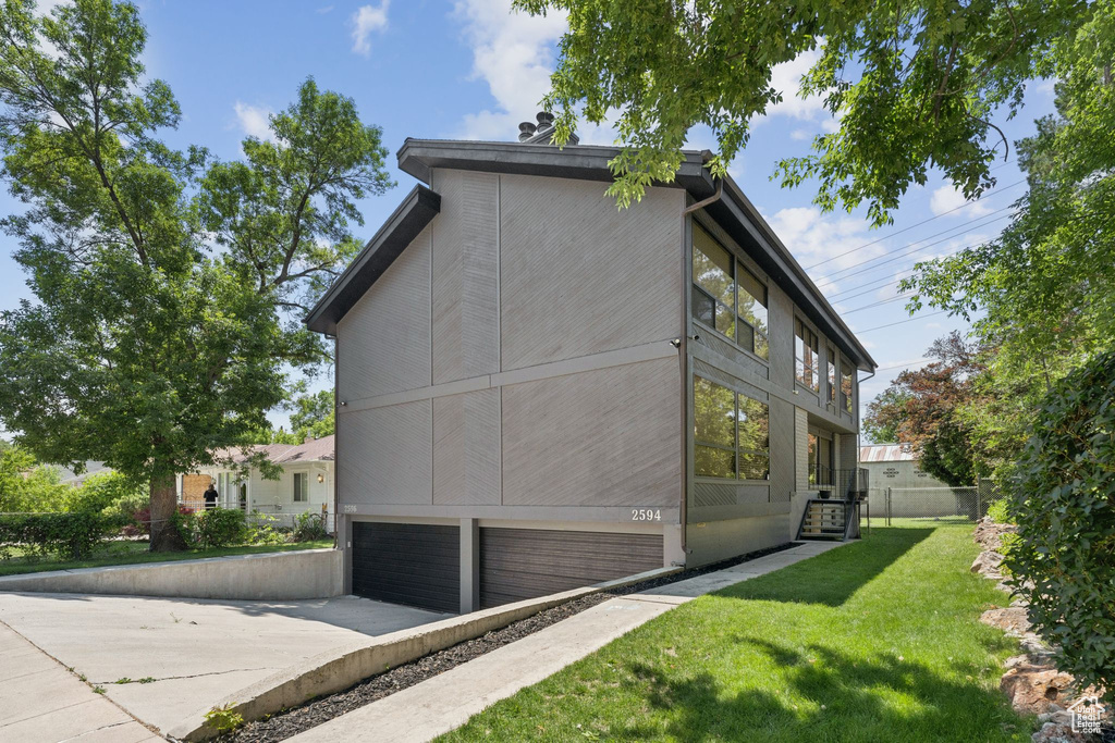 View of home\'s exterior with an attached garage and driveway