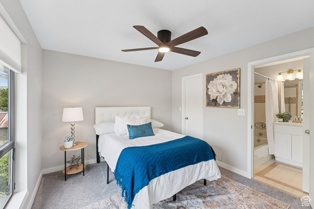 Bedroom featuring carpet floors, connected bathroom, ceiling fan, and baseboards