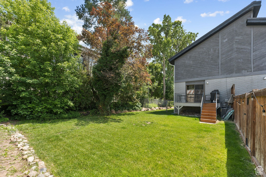 View of yard with stairway and a deck