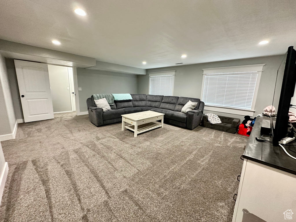 Living room with carpet floors, recessed lighting, and baseboards