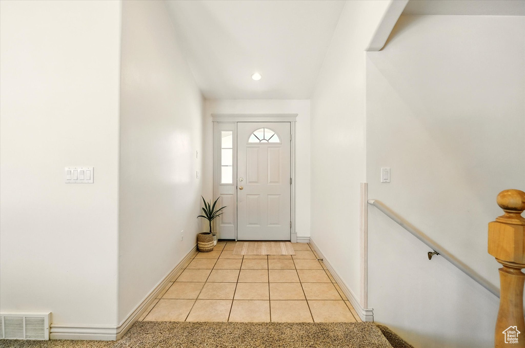 Entrance foyer featuring light tile patterned floors, baseboards, and recessed lighting