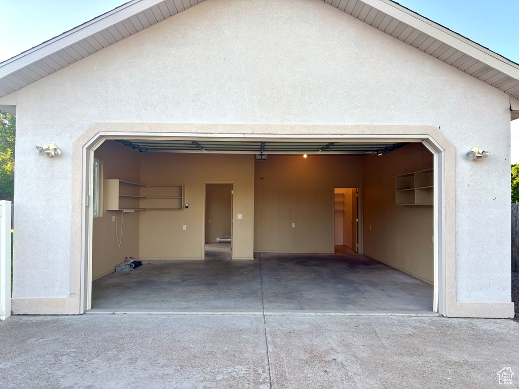 Garage featuring concrete driveway