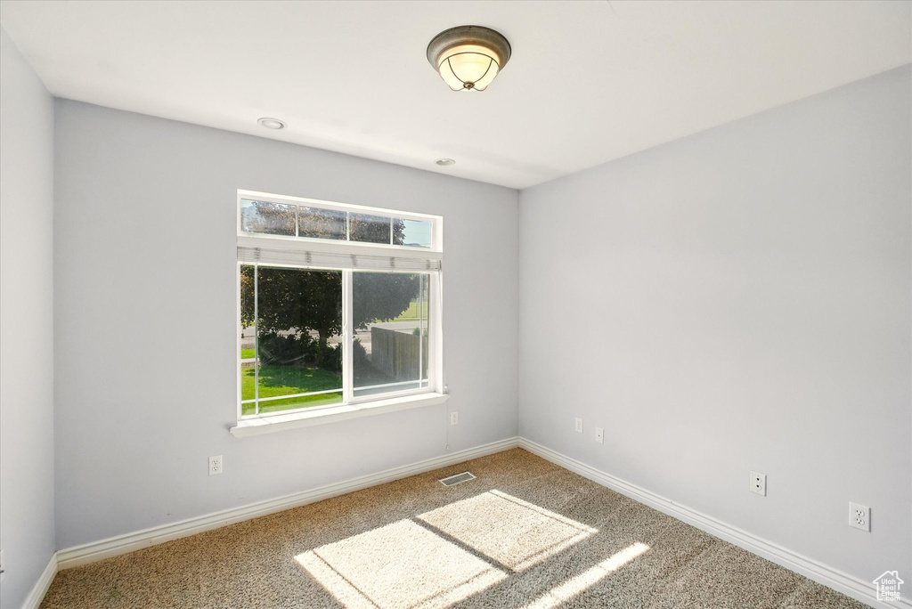 Unfurnished room with carpet and baseboards