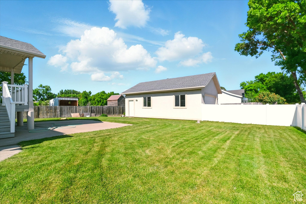 View of yard featuring a patio and stairway