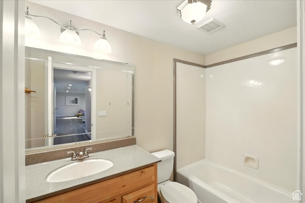 Full bathroom with vanity, toilet, and shower / bathtub combination