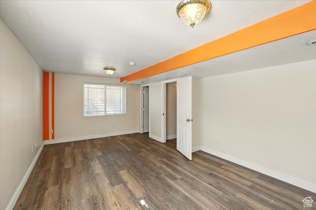 Empty room featuring wood finished floors and baseboards