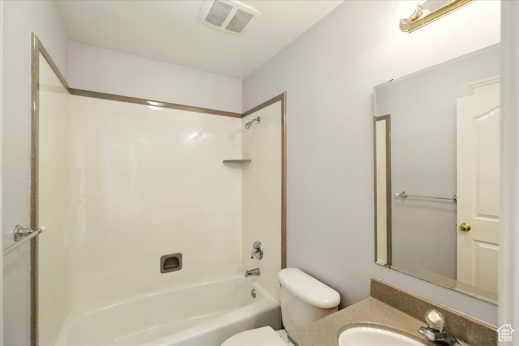 Full bathroom featuring toilet, shower / bathtub combination, and vanity