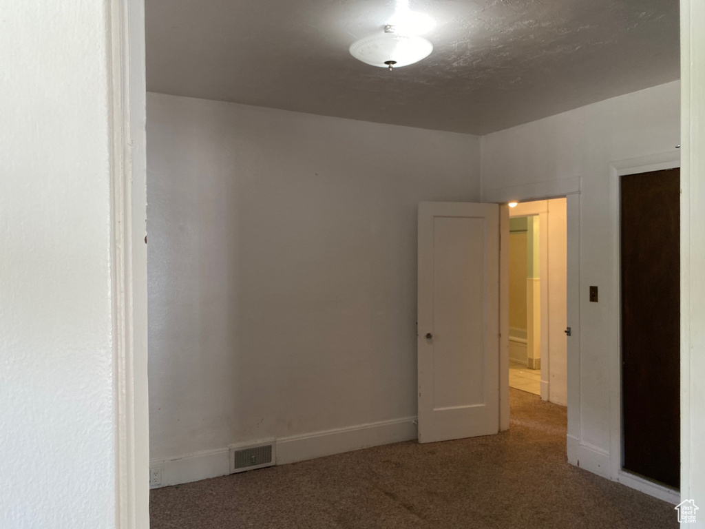 Unfurnished room with carpet and baseboards