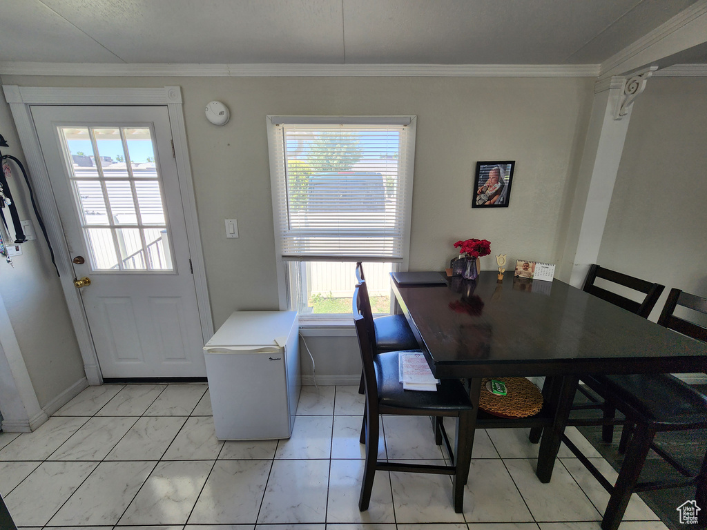 Dining area featuring baseboards and crown molding