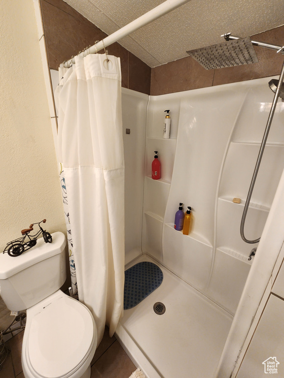 Full bathroom with a shower stall and toilet