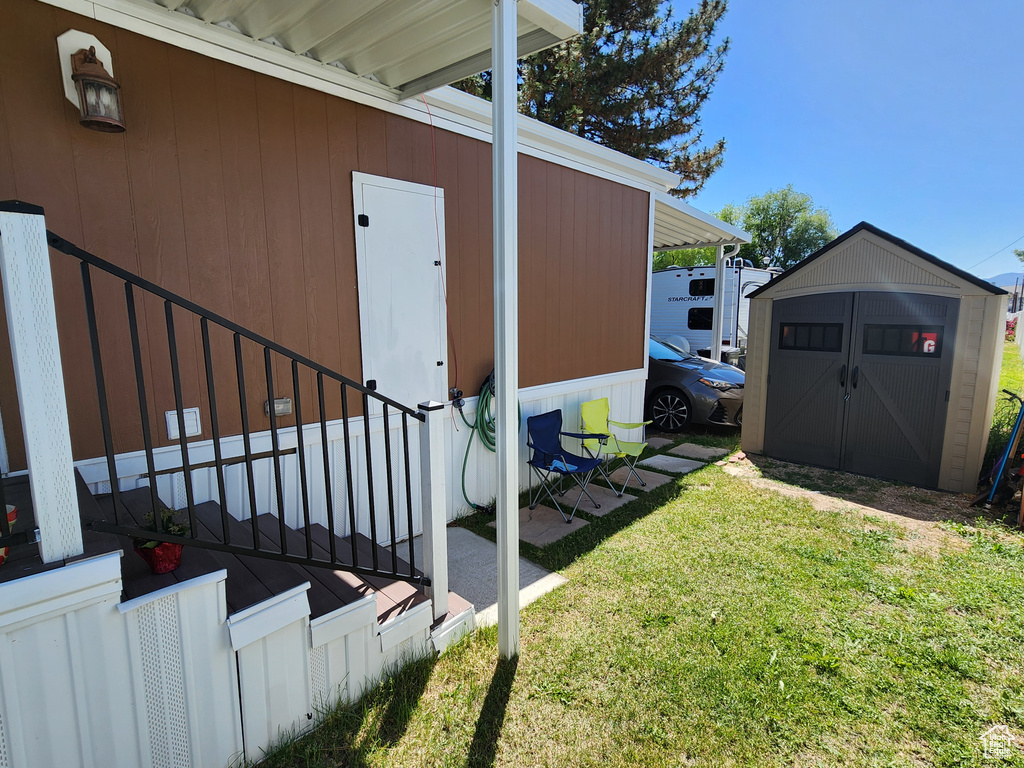 View of exterior entry with a lawn