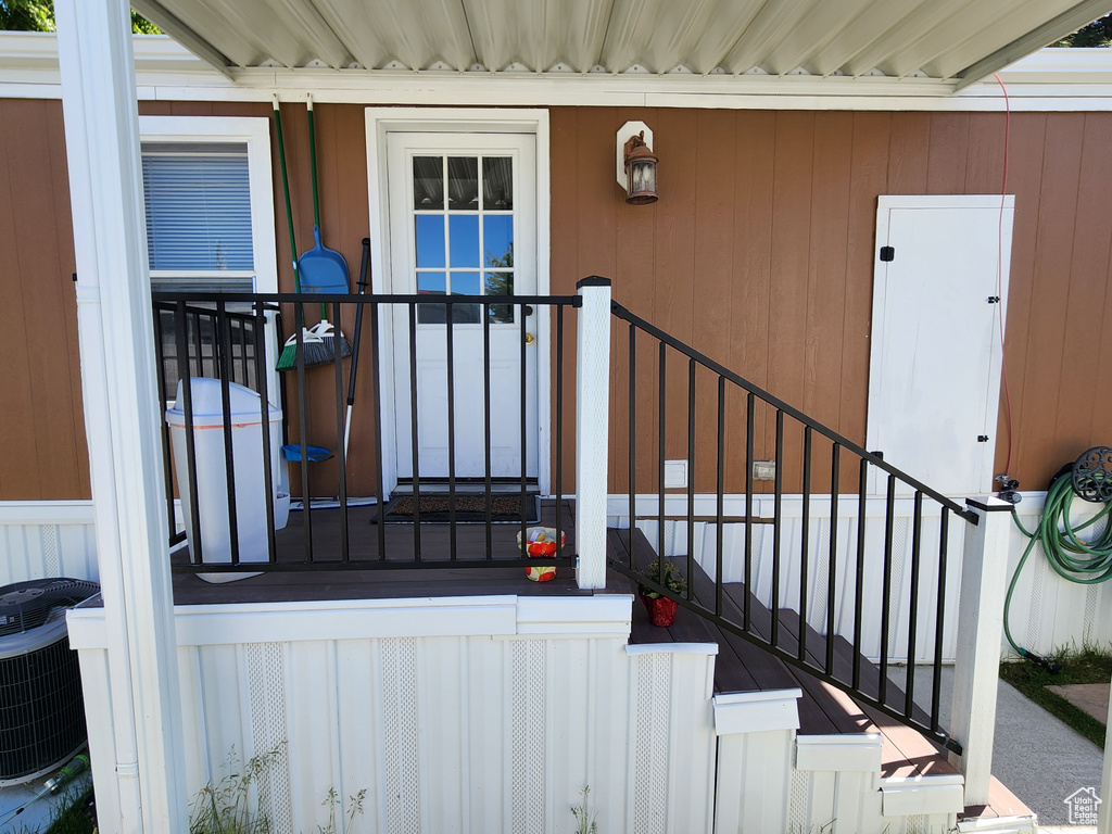 Entrance to property featuring central air condition unit