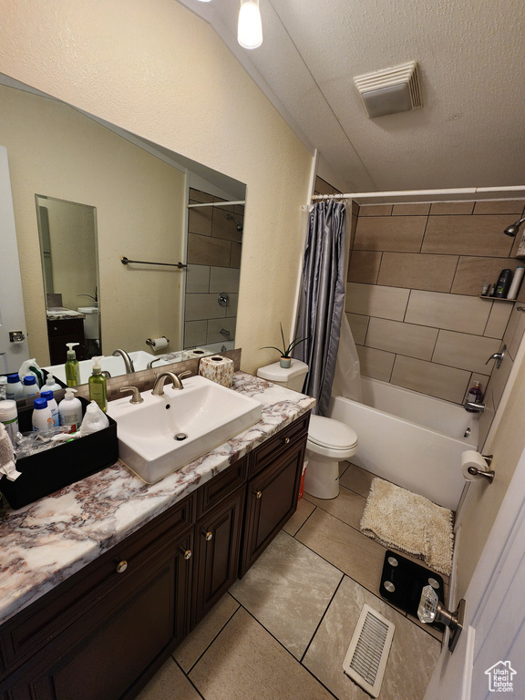 Full bathroom with toilet, vanity, shower / bathtub combination with curtain, and tile patterned flooring