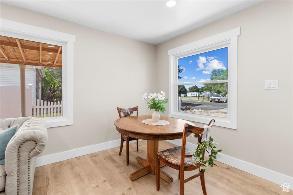 Dining room featuring light wood-style floors, baseboards, and recessed lighting