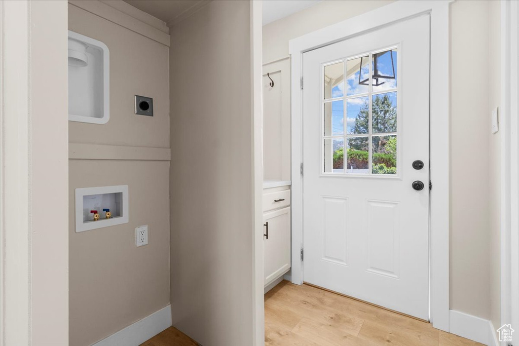 Laundry room featuring electric dryer hookup, hookup for a washing machine, and light wood-style flooring