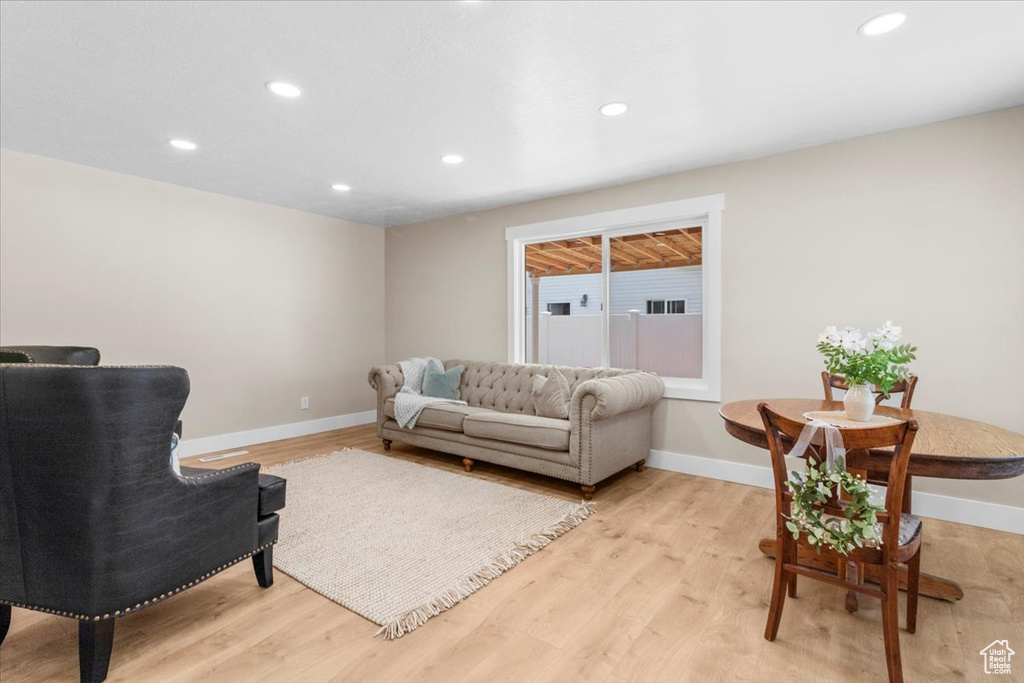 Living room featuring light wood finished floors, recessed lighting, and baseboards