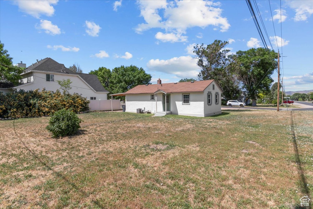 Back of property featuring stucco siding and entry steps