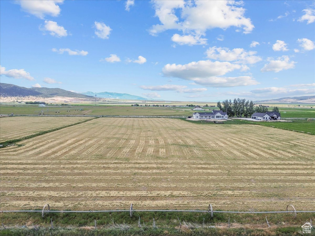 Overview of rural landscape featuring a mountainous background and farmland