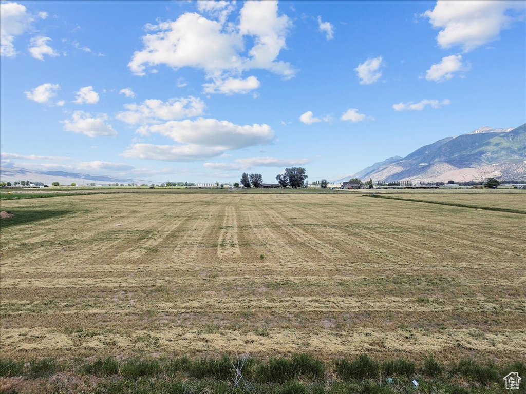 View of yard featuring a rural view and a mountain view