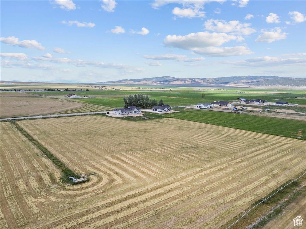 Aerial view of sparsely populated area featuring a mountain backdrop and farmland