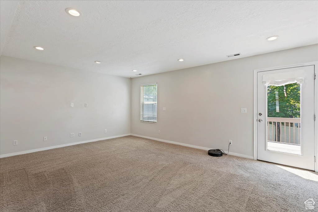 Unfurnished room featuring carpet, recessed lighting, baseboards, and a textured ceiling