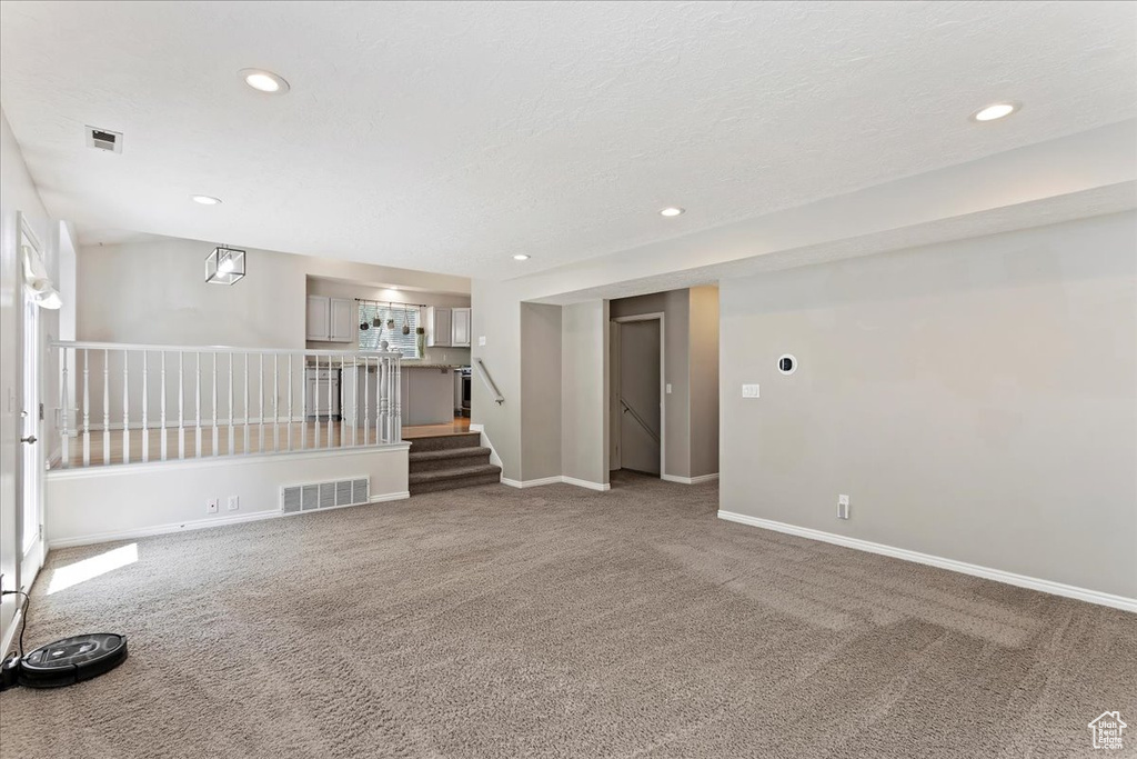 Empty room featuring carpet floors, recessed lighting, and baseboards