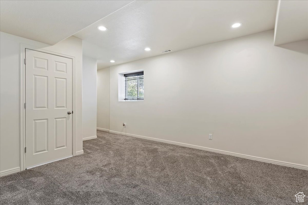 Unfurnished room featuring carpet floors, baseboards, and recessed lighting