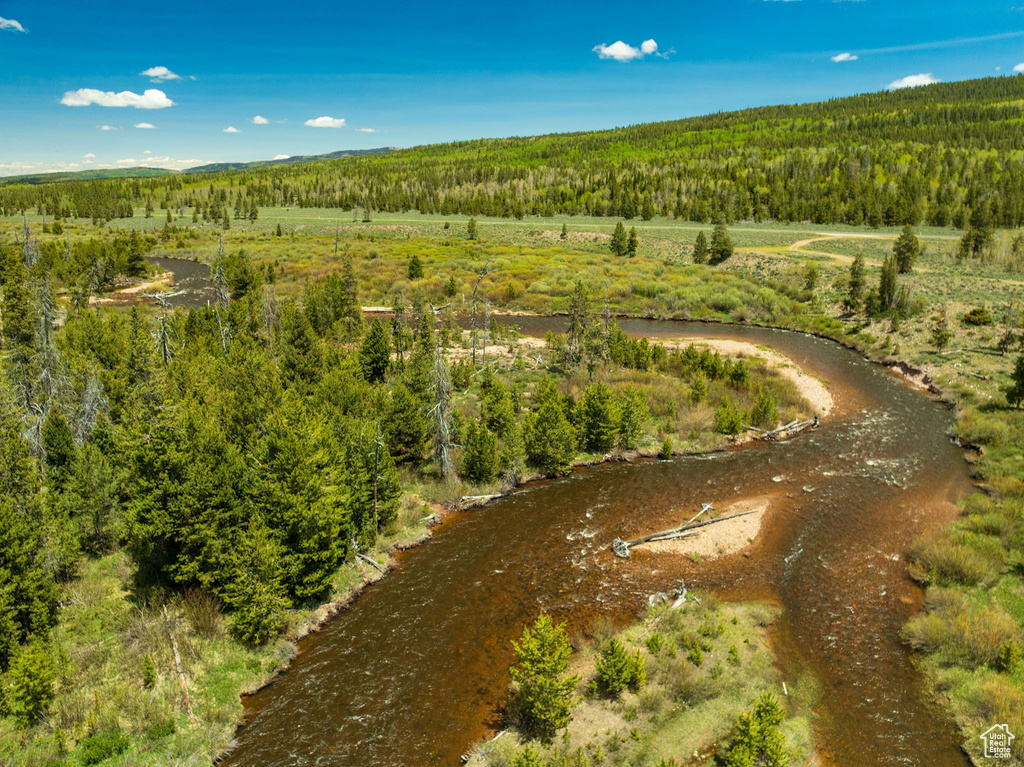 Aerial view of property and surrounding area with a heavily wooded area