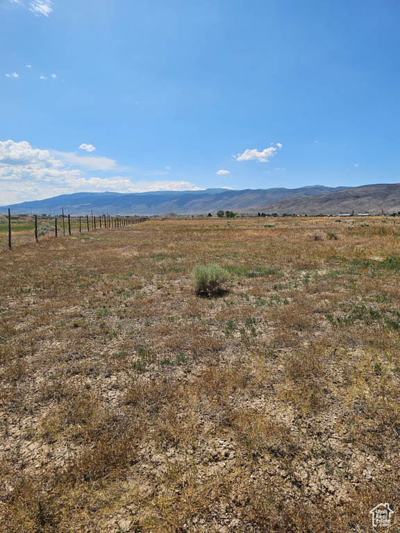 View of mountain backdrop with rural landscape