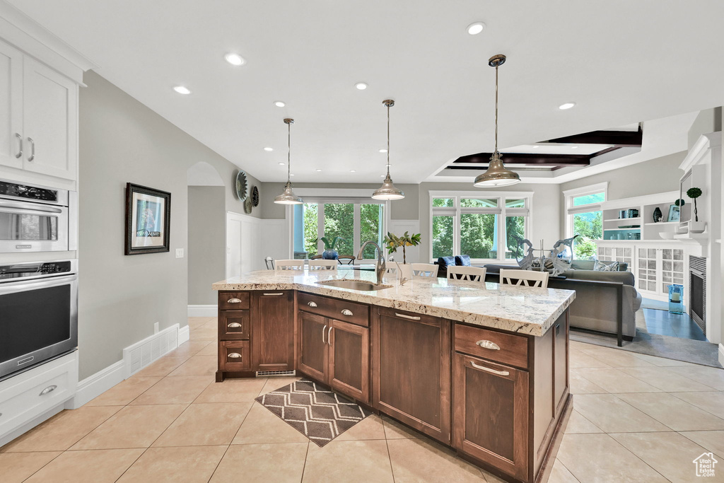 Kitchen featuring a sink, recessed lighting, light tile patterned flooring, healthy amount of natural light, and pendant lighting